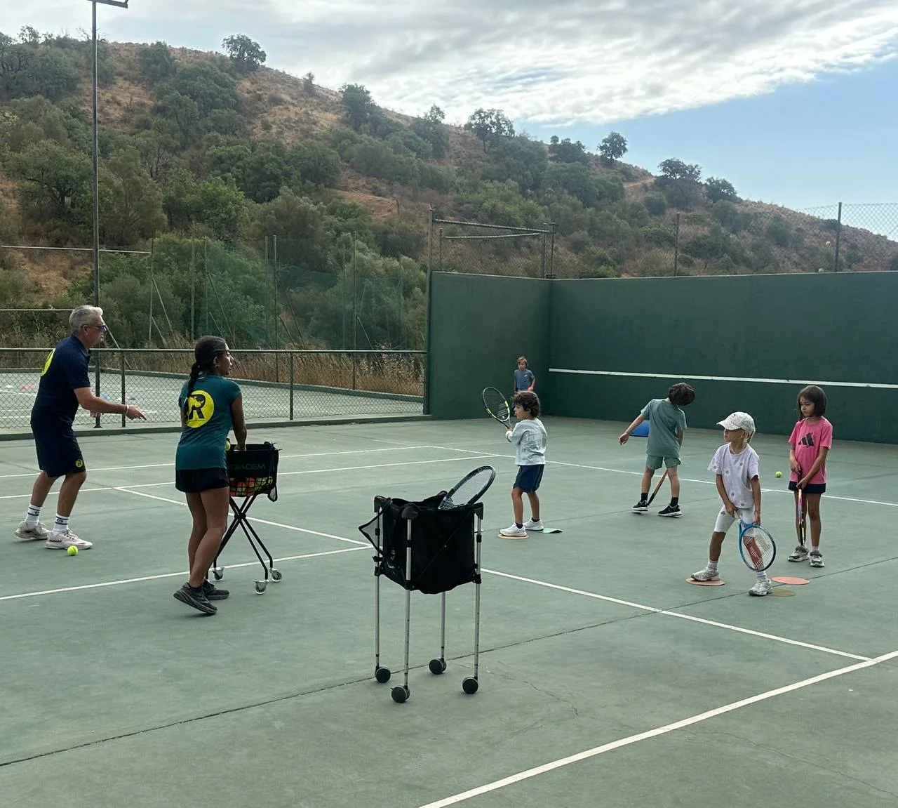 Children learning tennis together at the academy