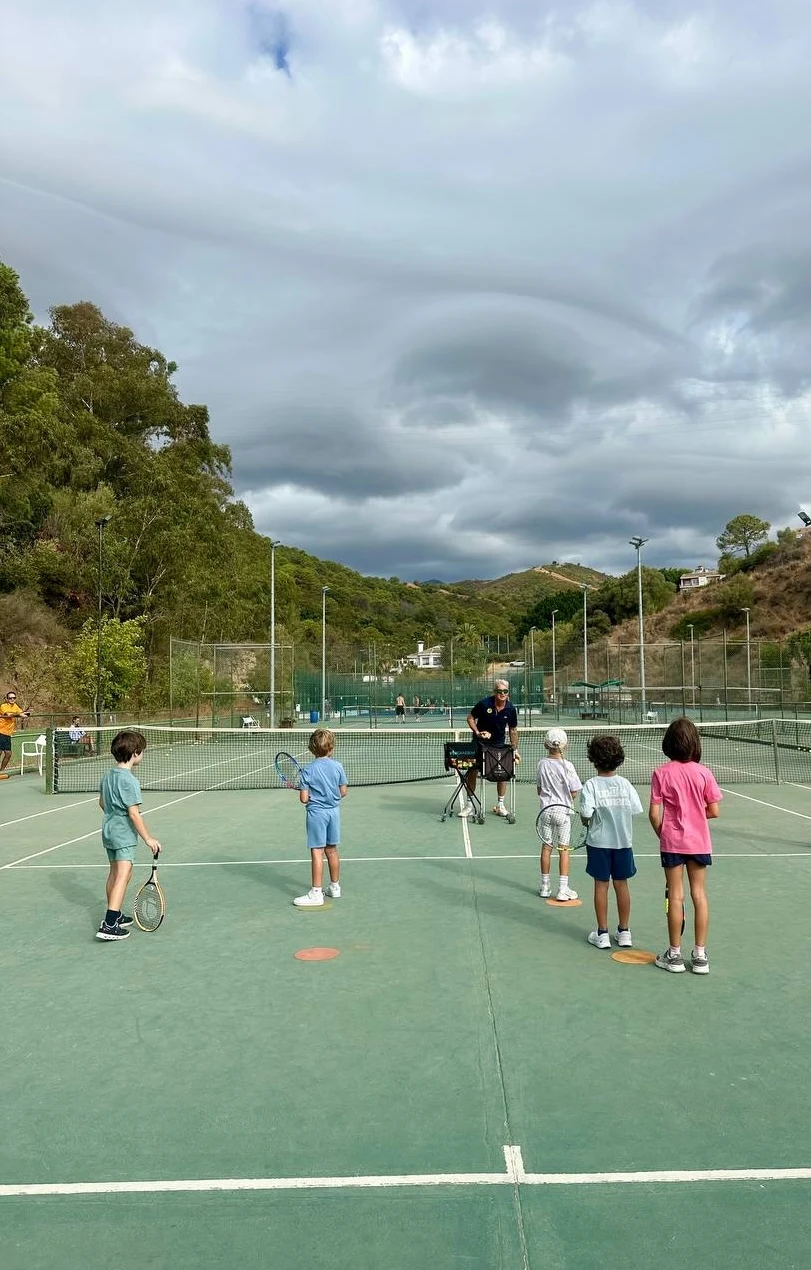 Children and coaches learning together in a junior group session