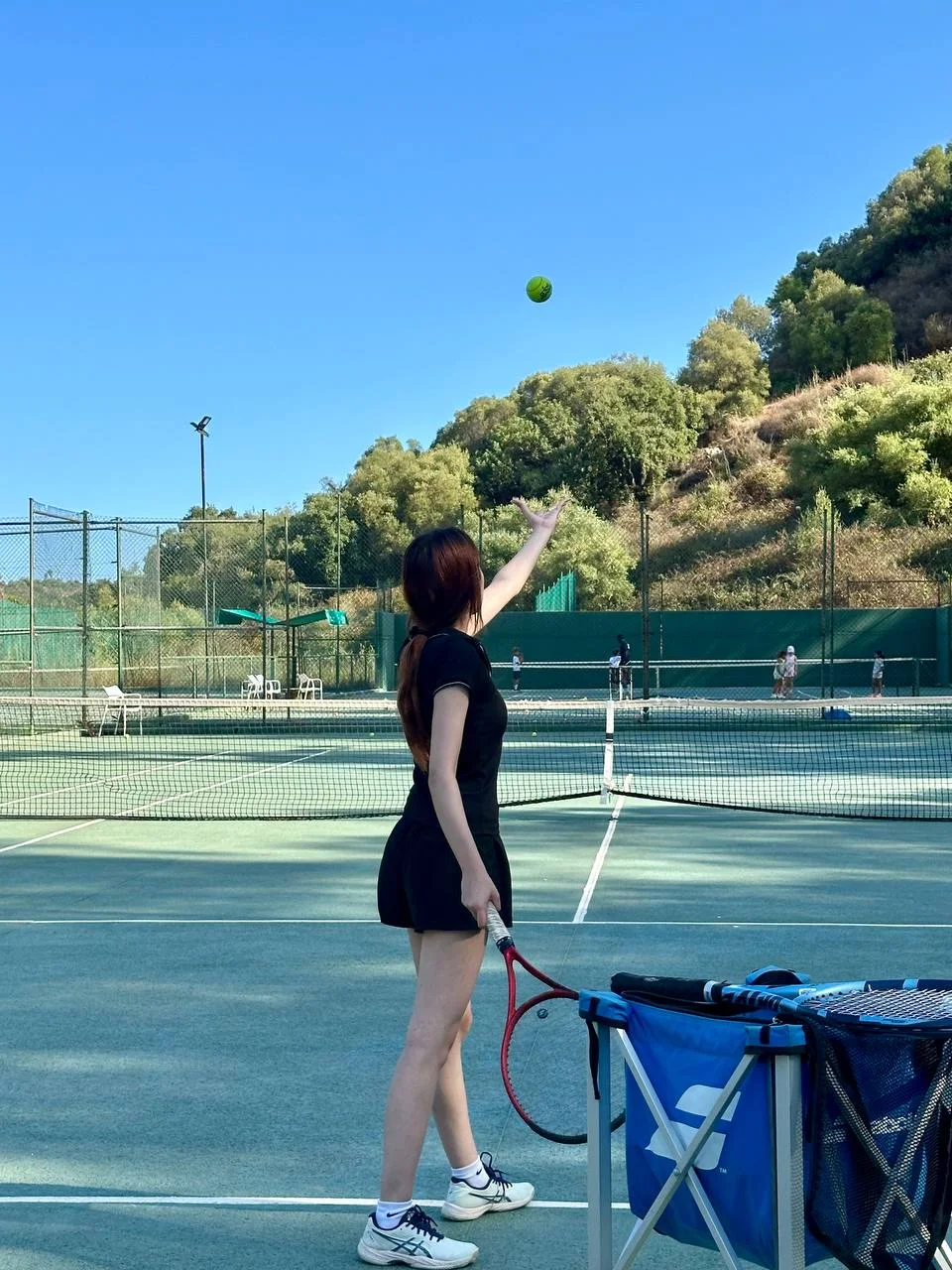 Rhino player practising her ball toss before serving