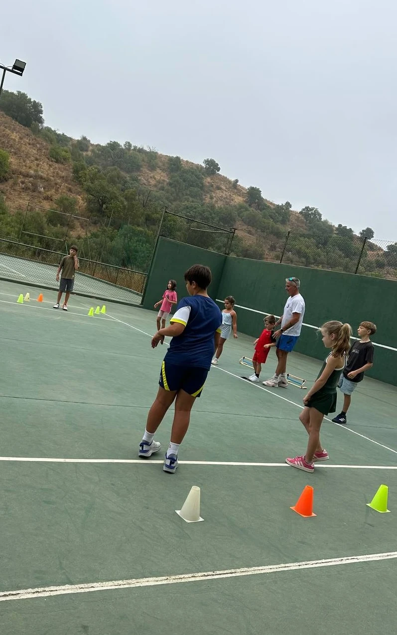 Players and coaches in a group tennis session